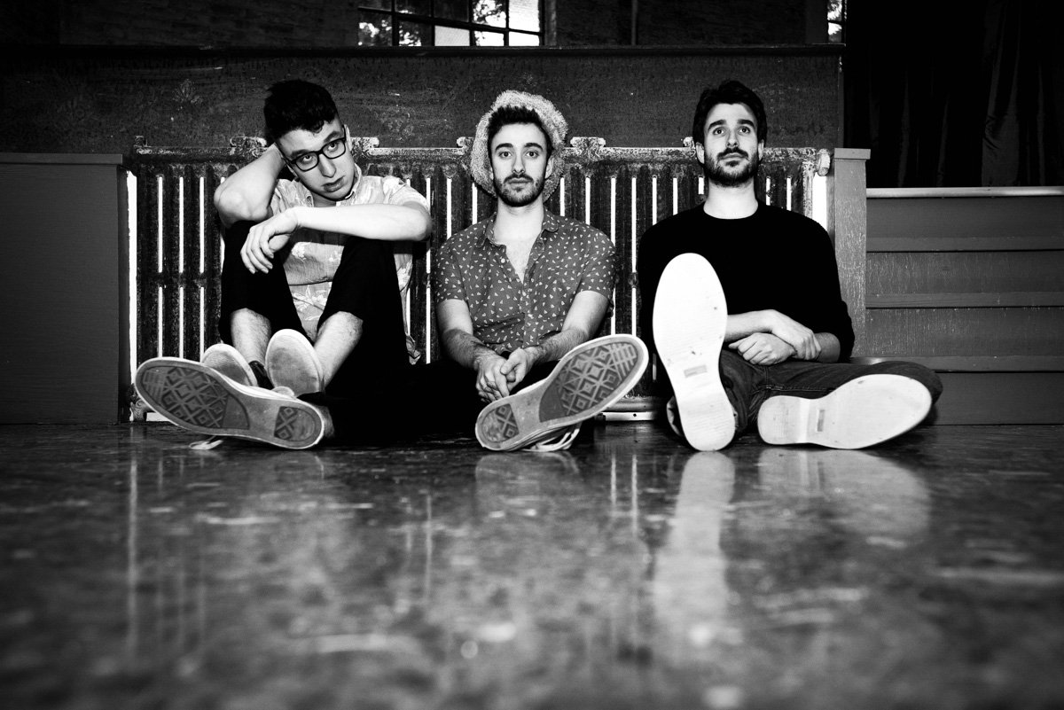 black and white picture of AJR band sitting