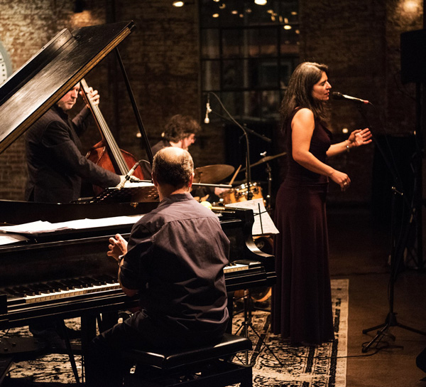 woman singing with band members