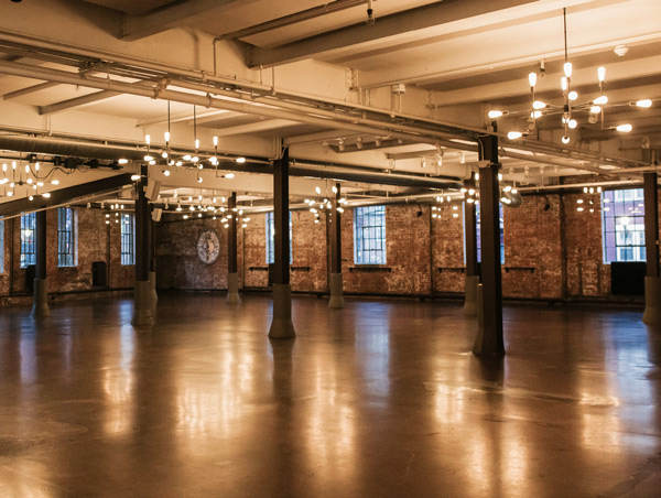 venue showing raw brick with industrial chandeliers
