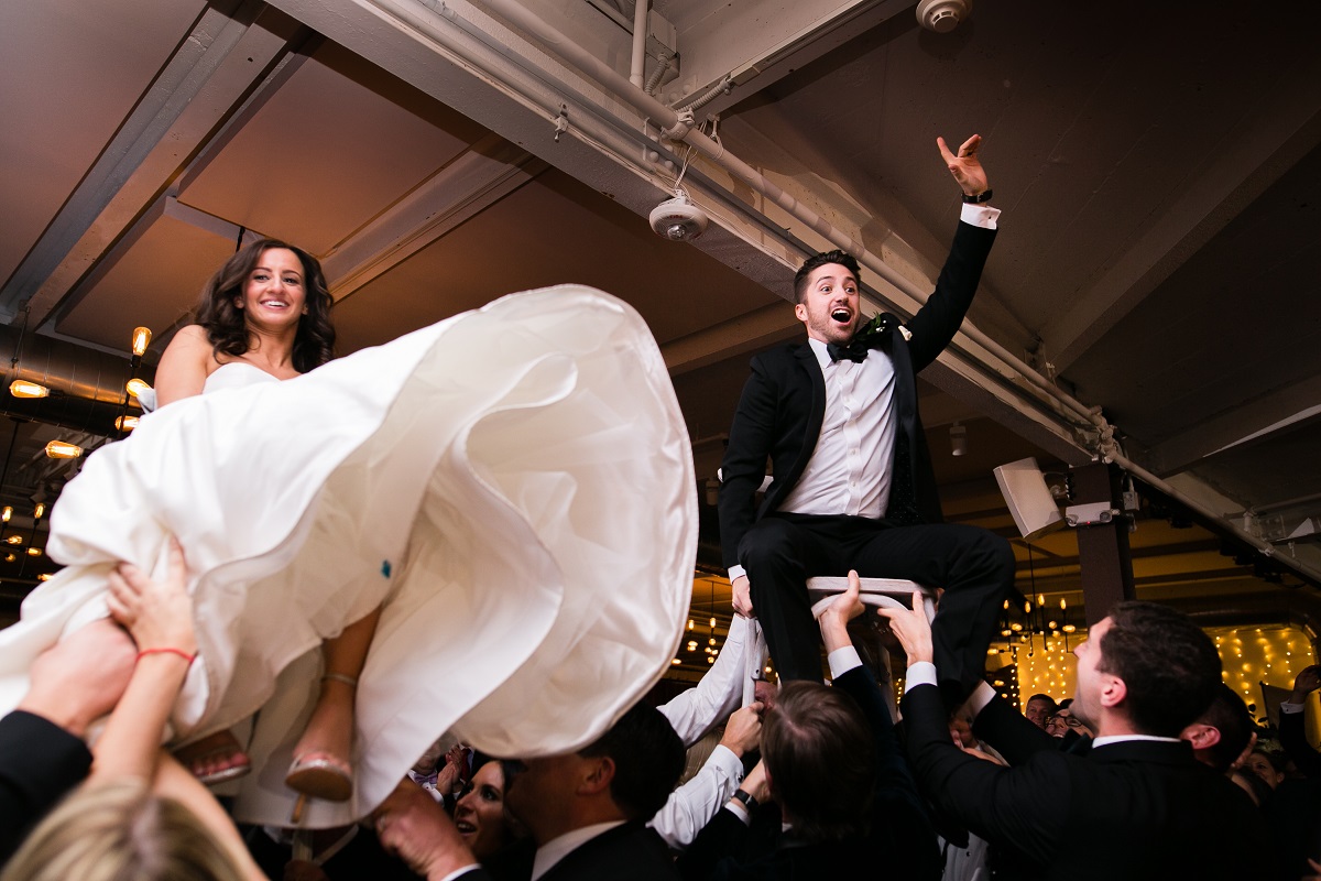 couple being lifted on chairs